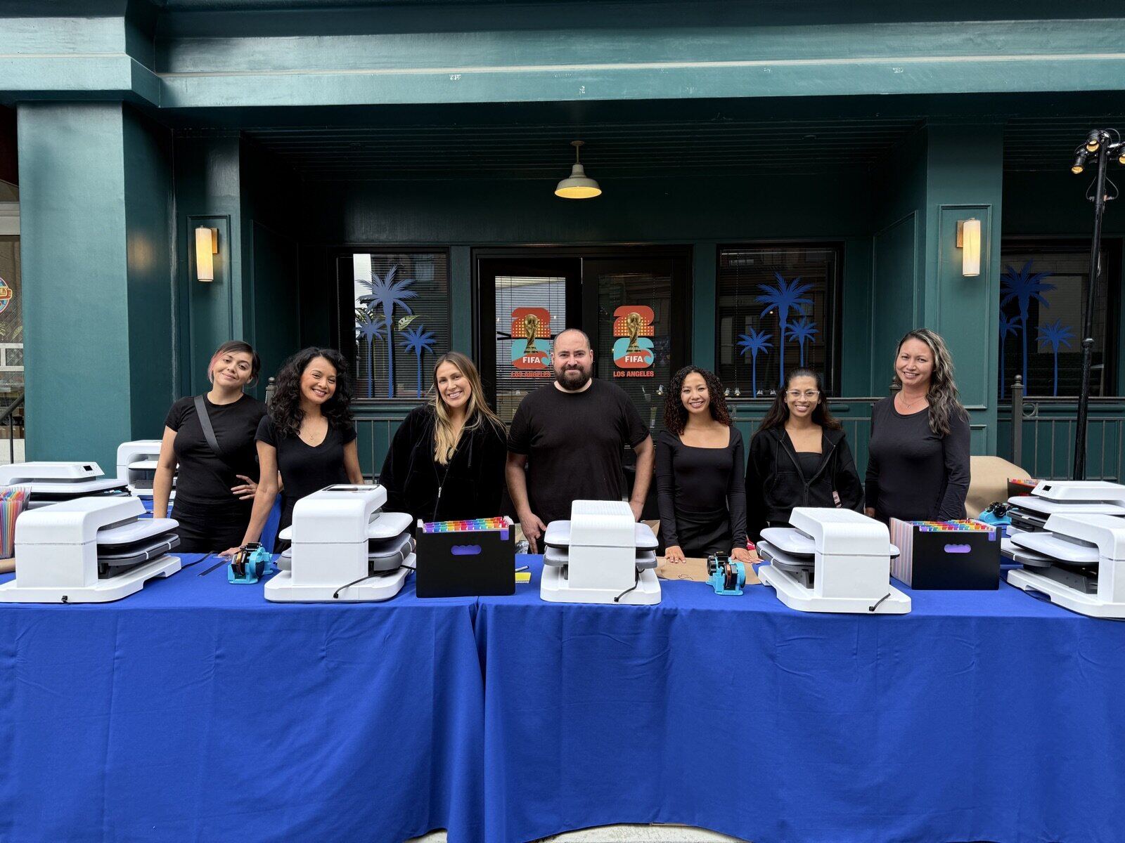 Live DTF t-shirt printing station pressing a custom transfer at a booth