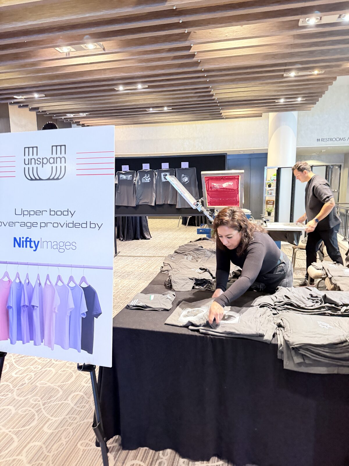 Merch Troop live t-shirt printing station on a trade show booth merch table