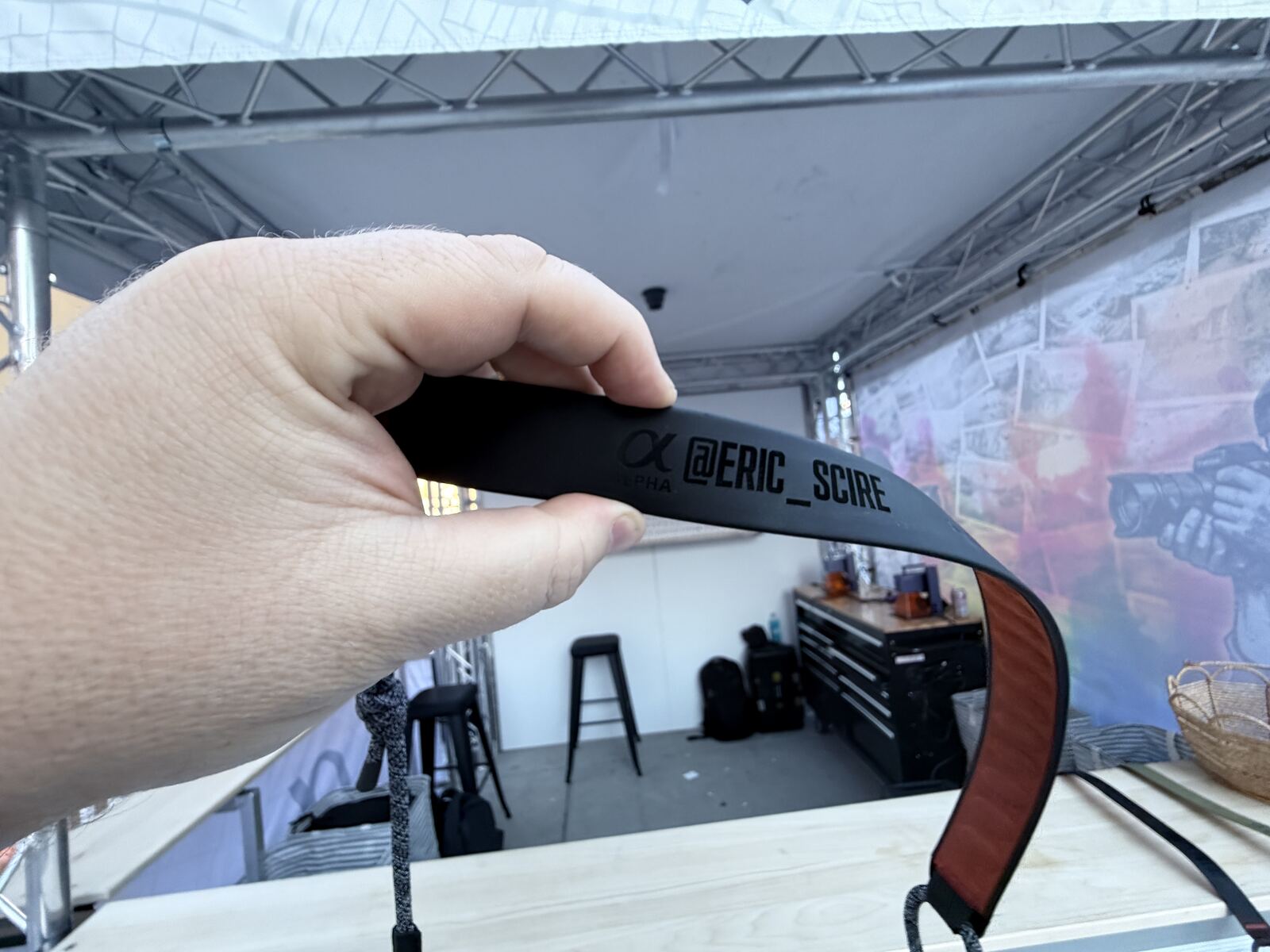 Close-up of a person holding an event credential or wristband at a corporate venue