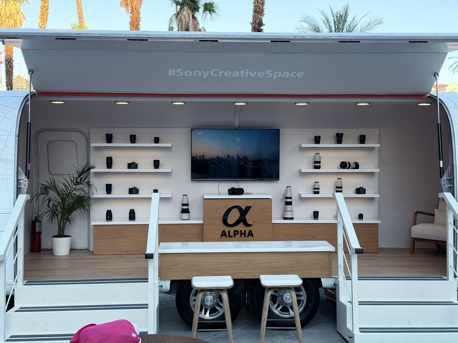 Professional Sony Alpha equipment display trailer at an outdoor event with palm trees